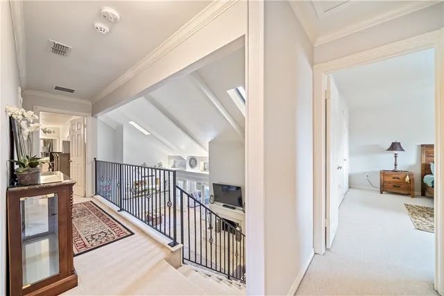 a view of a hallway with a livingroom and furniture