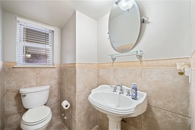 a bathroom with a sink a mirror and a toilet