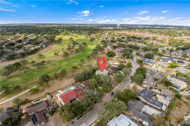 an aerial view of residential houses with outdoor space and river