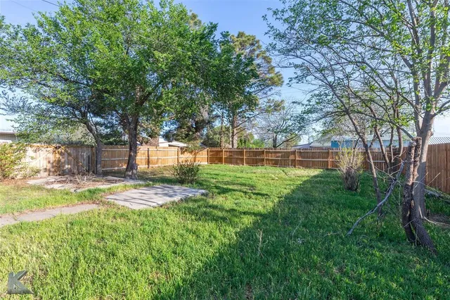 a view of a yard with a tree