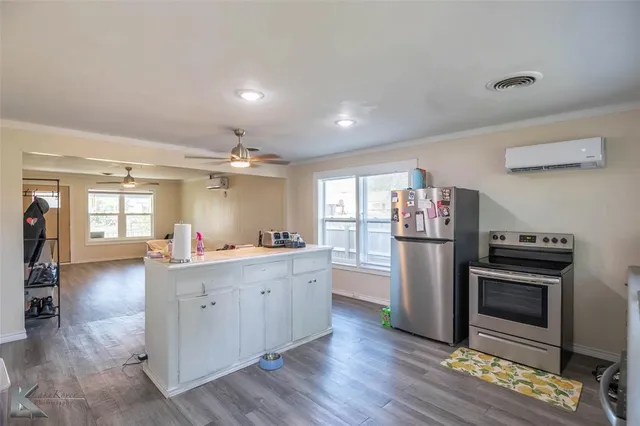 a kitchen with refrigerator and cabinets