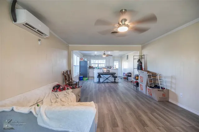 a living room with furniture and chandelier