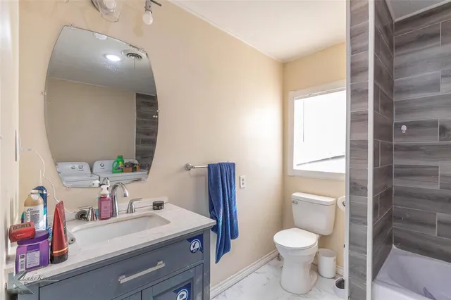 a bathroom with a sink a toilet and vanity