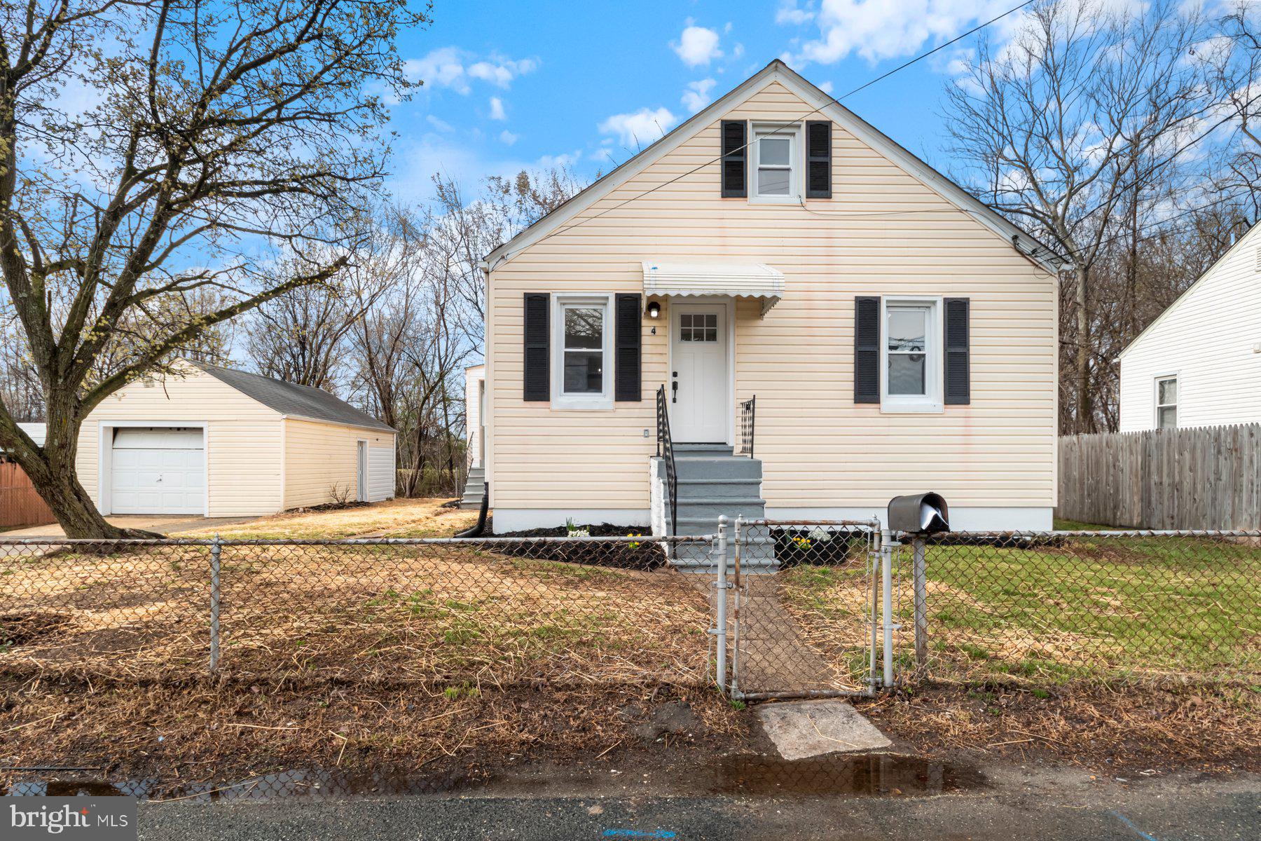 a view of a yard in front of a house with large trees