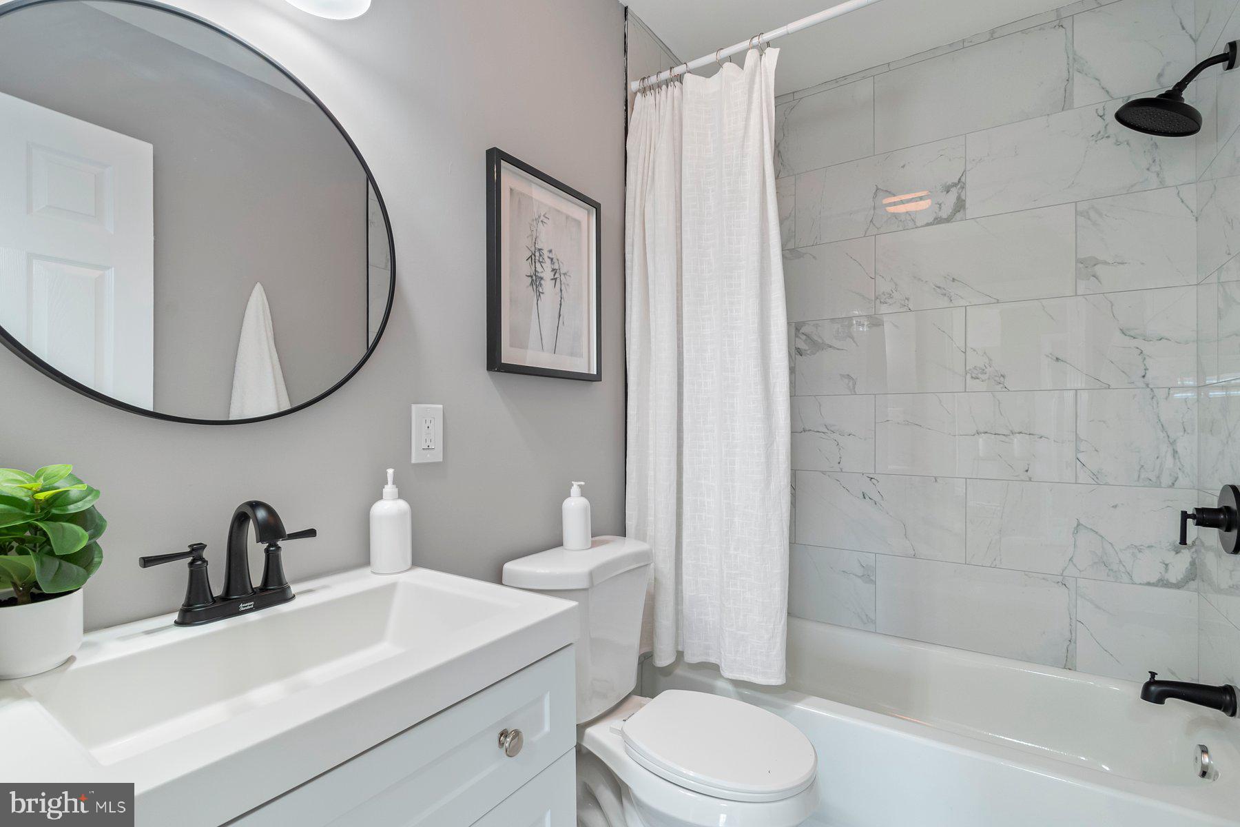 4 North Point Terrace Baltimore, MD 21222 - Photo 17 of 32 a bathroom with a sink a toilet and a mirror