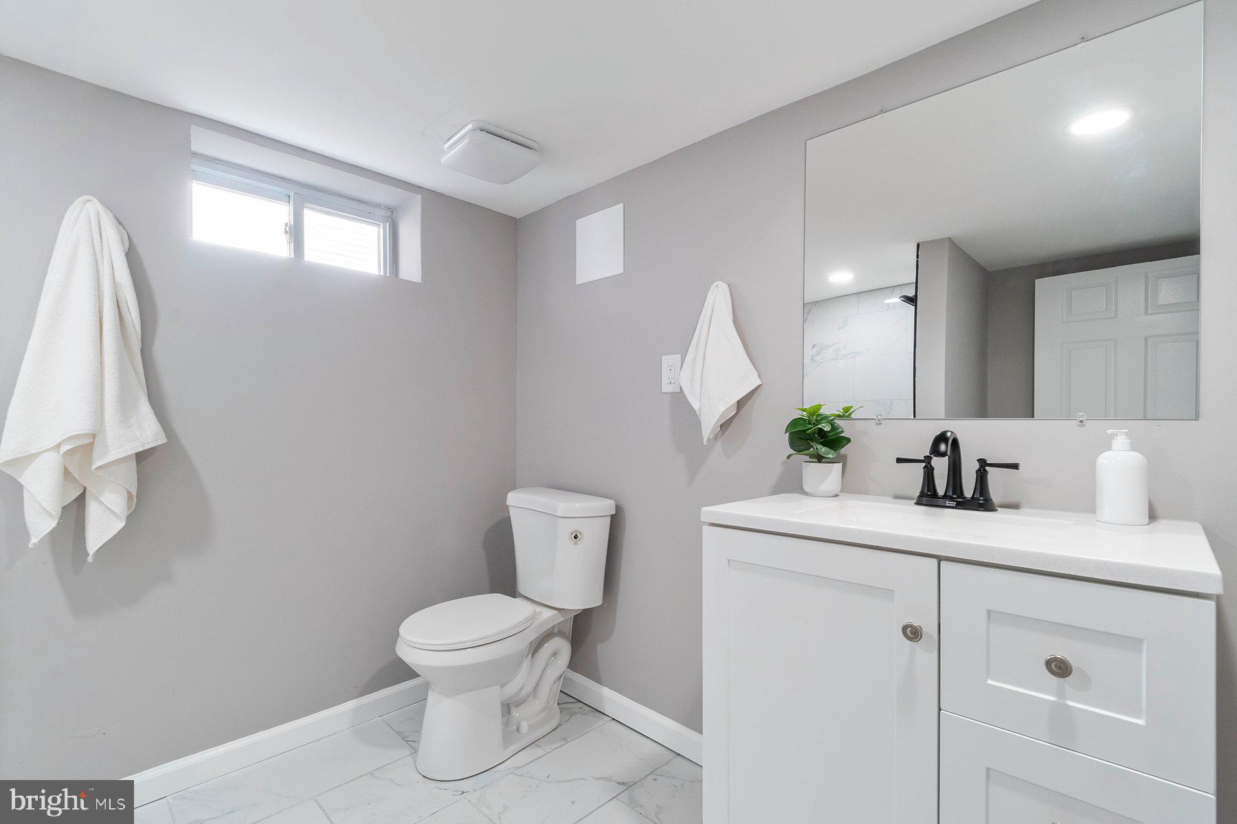 4 North Point Terrace Baltimore, MD 21222 - Photo 22 of 32 a bathroom with a toilet sink and mirror
