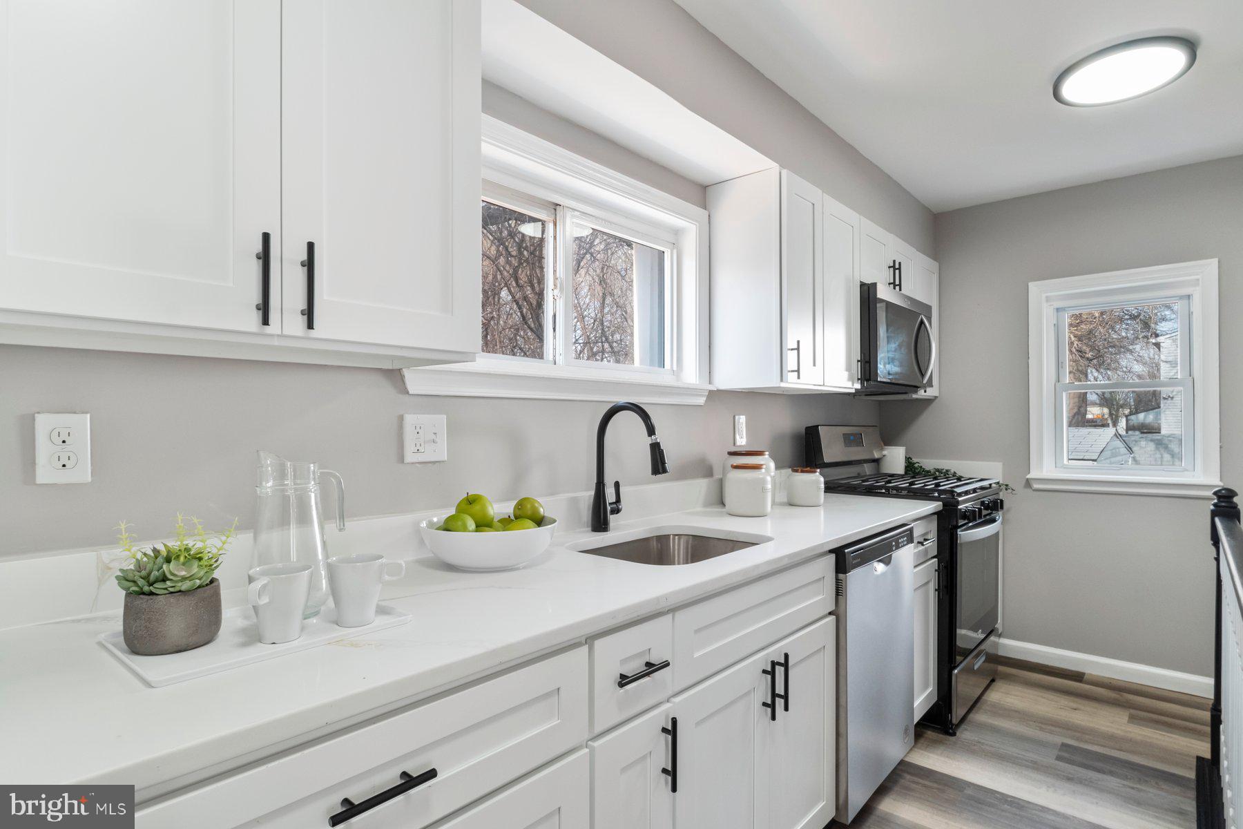 4 North Point Terrace Baltimore, MD 21222 - Photo 8 of 32 a kitchen with stainless steel appliances granite countertop a sink and a white cabinets