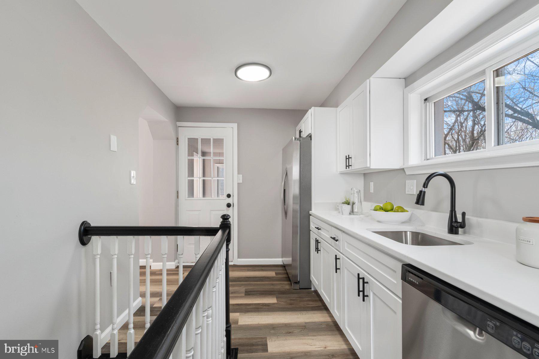 4 North Point Terrace Baltimore, MD 21222 - Photo 9 of 32 a kitchen with a sink a refrigerator and cabinets