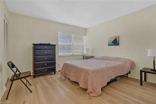 a bedroom with a bed and a chair