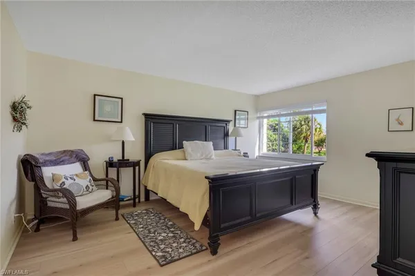 a bedroom with a bed and a chair