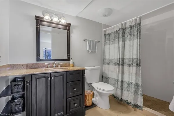 a bathroom with a toilet a sink and glass door