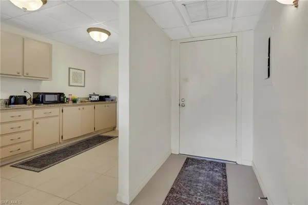a kitchen with granite countertop a sink and cabinets