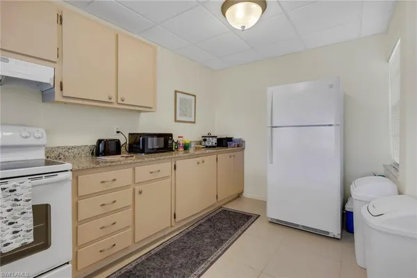 a kitchen with cabinets stainless steel appliances and sink