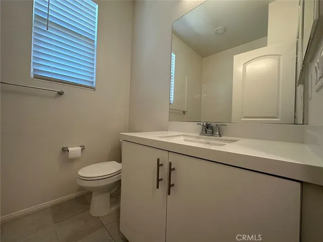a bathroom with a sink toilet and mirror
