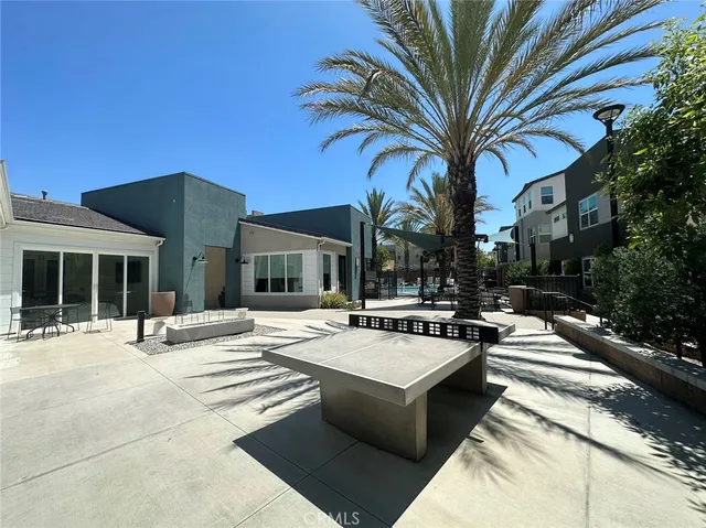 a view of a house with swimming pool and sitting area