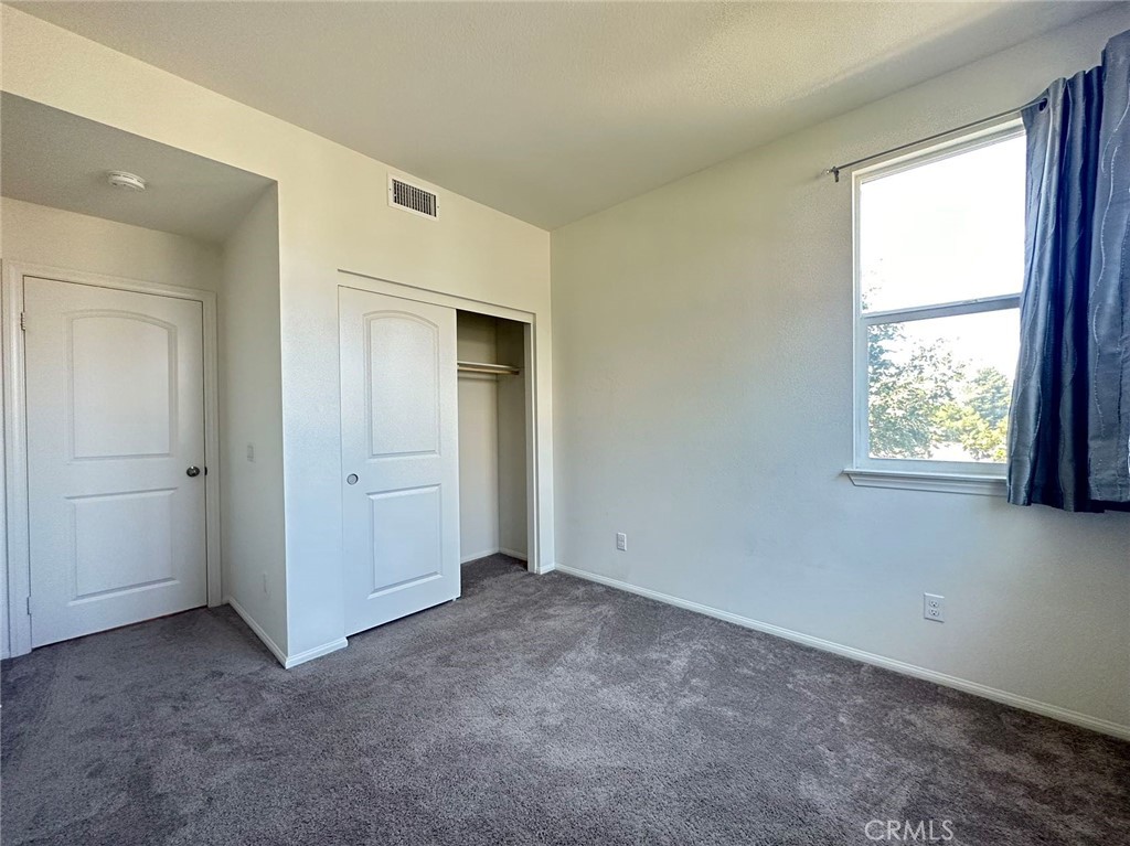 10517 Huxley Drive Rancho Cucamonga, CA 91730 - Photo 7 of 16 an empty room with windows and closet