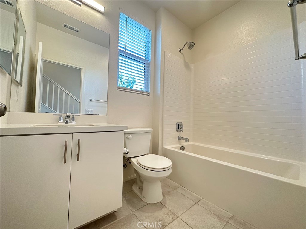 10517 Huxley Drive Rancho Cucamonga, CA 91730 - Photo 8 of 16 a bathroom with a toilet sink and mirror