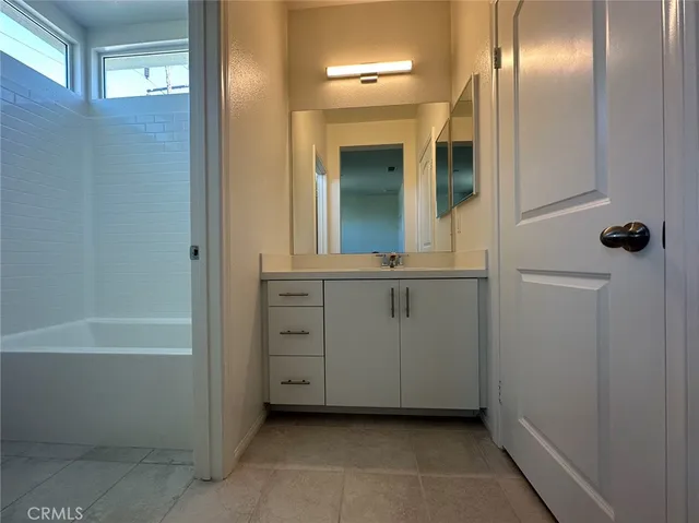 a bathroom with a bathtub and a sink