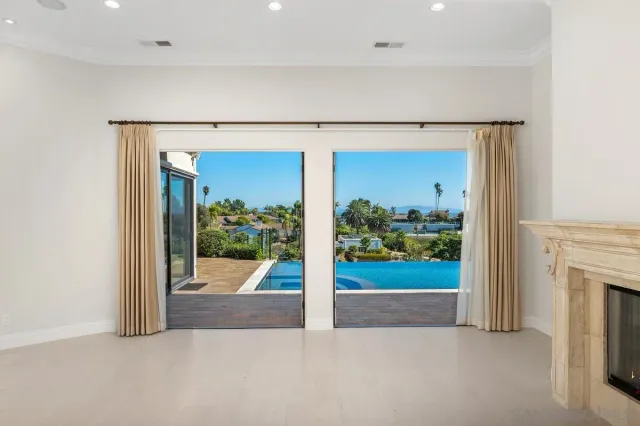 a view of a big room with windows and entryway