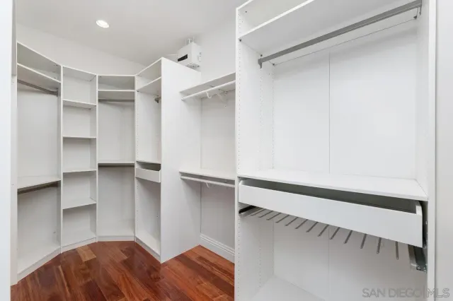 a view of walk in closet with empty racks