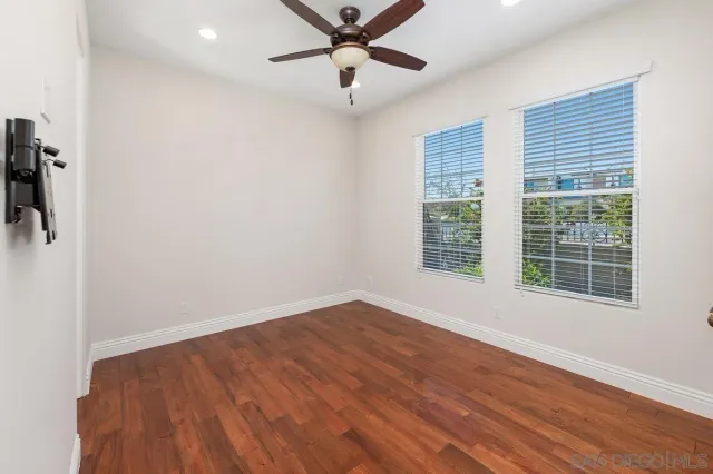 wooden floor in an empty room with a window