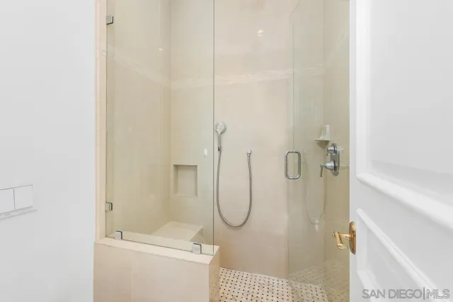 a bathroom with a glass shower door
