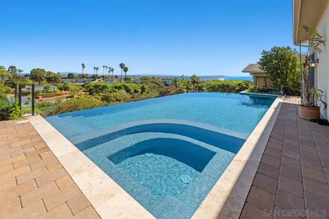 a view of swimming pool with a chairs