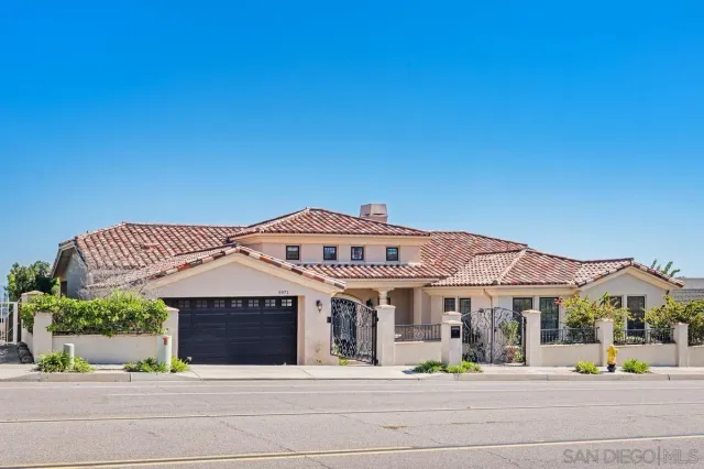 a front view of a building with a garden