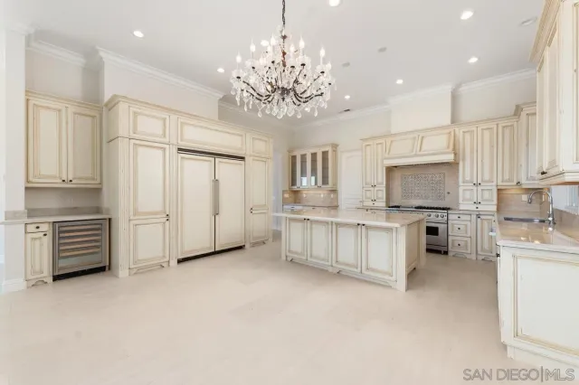 a large white kitchen with cabinets