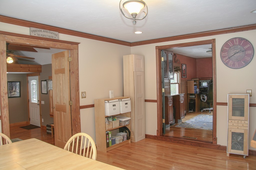 52 Marlboro Road Berlin, MA 01503 - Photo 8 of 30 a view of a livingroom kitchen and dinning room with wooden floor