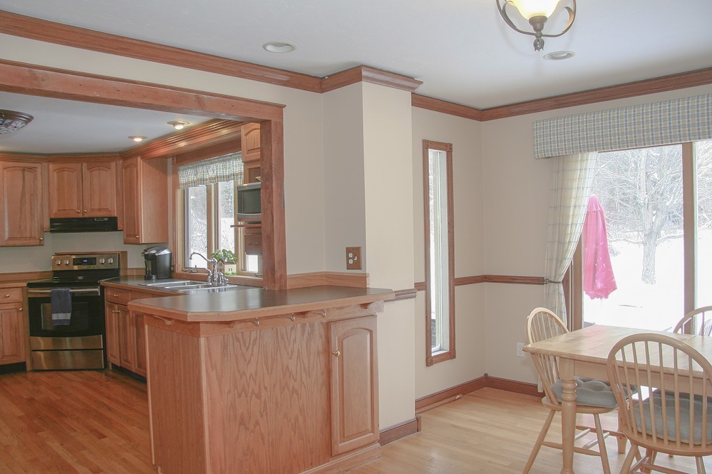 52 Marlboro Road Berlin, MA 01503 - Photo 9 of 30 a kitchen with kitchen island granite countertop a stove and a sink