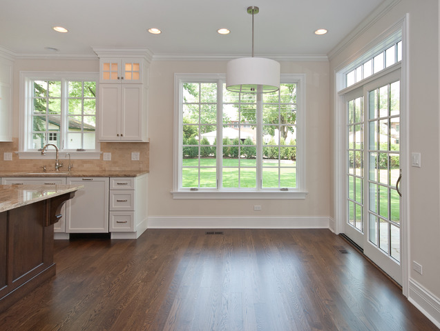 420 Washington Street Glenview, IL 60025 - Photo 4 of 17 a open kitchen with kitchen island wooden floors wooden cabinets and a large window