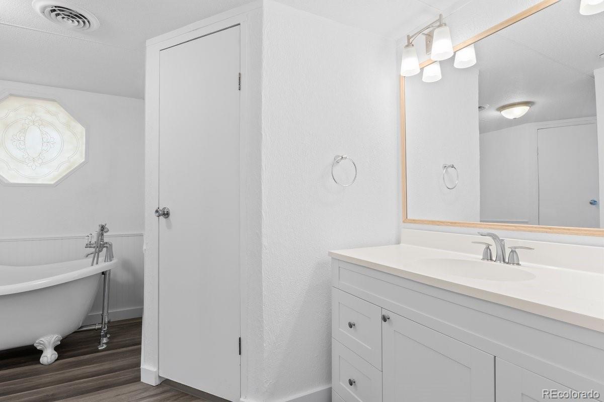 400 Hickory Street Fort Collins, CO 80524 - Photo 11 of 28 a bathroom with a toilet a sink and mirror