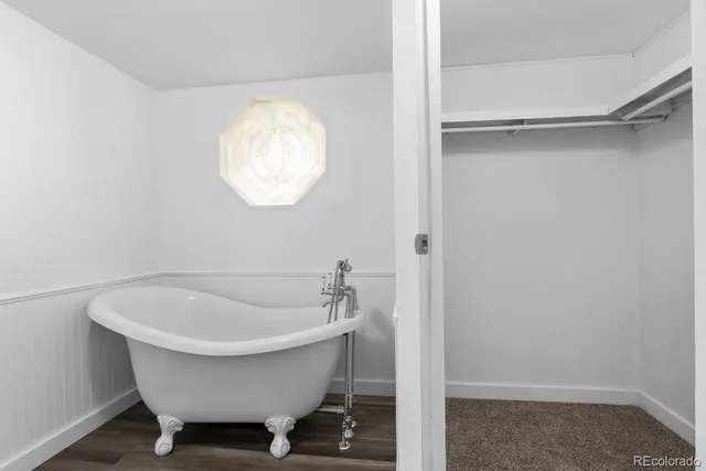 a bathroom with a tub and a sink