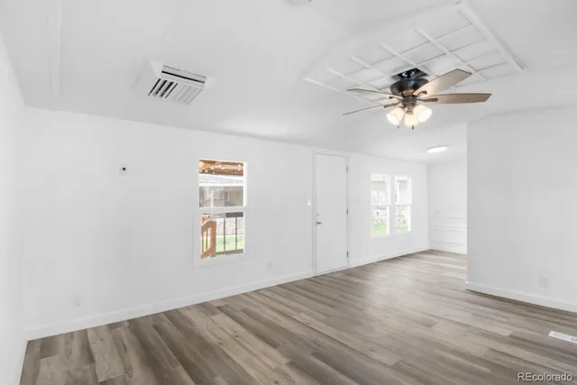 wooden floor in an empty room with a window
