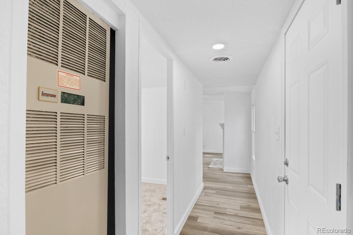 400 Hickory Street Fort Collins, CO 80524 - Photo 17 of 28 a view of a hallway with wooden floor and staircase