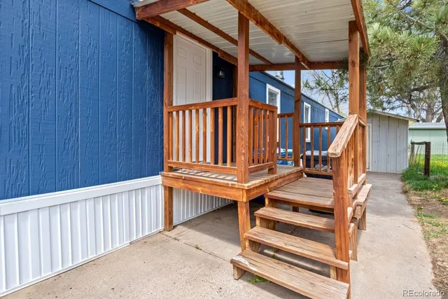 an outdoor view of staircase with railing and white walls