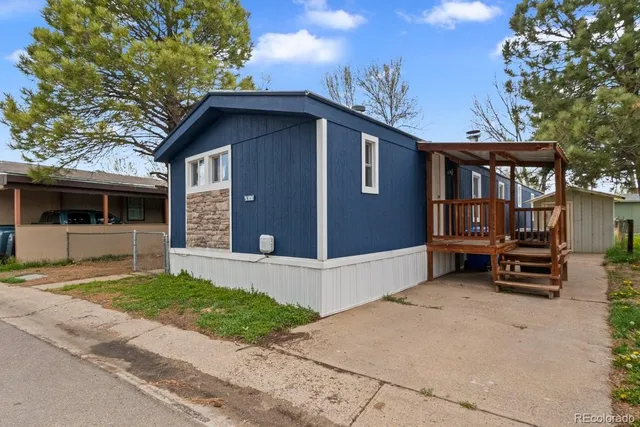 a view of a house with a yard and wooden fence