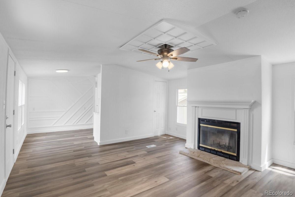 400 Hickory Street Fort Collins, CO 80524 - Photo 3 of 28 a view of an empty room with wooden floor and fireplace
