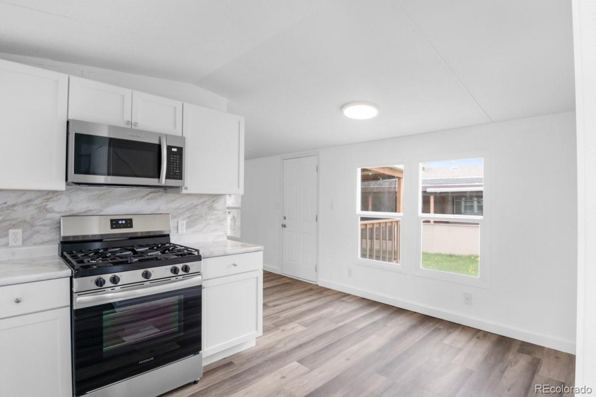 400 Hickory Street Fort Collins, CO 80524 - Photo 5 of 28 a kitchen with stainless steel appliances a stove microwave and sink