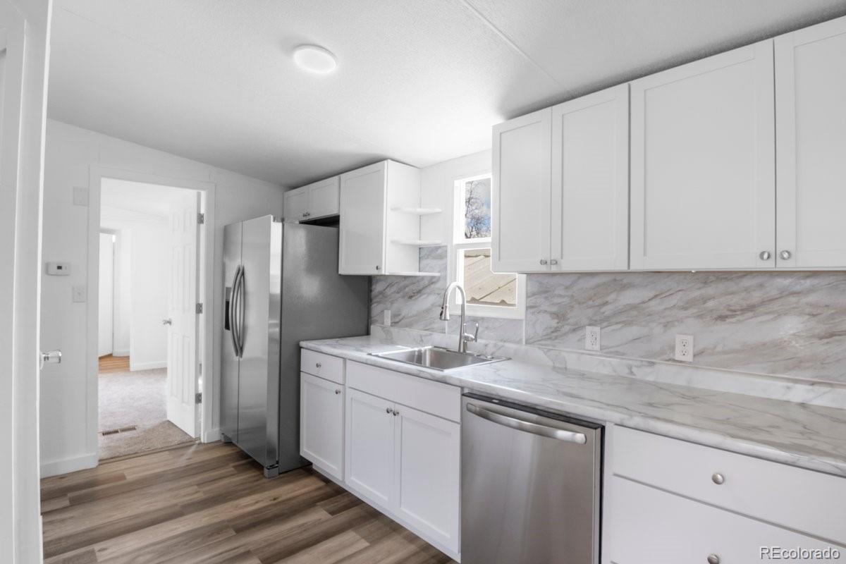 400 Hickory Street Fort Collins, CO 80524 - Photo 6 of 28 a kitchen with stainless steel appliances granite countertop a sink and a refrigerator