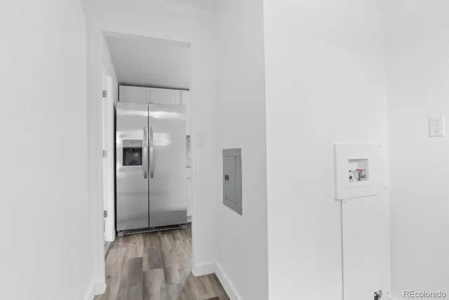 a view of a hallway with wooden floor