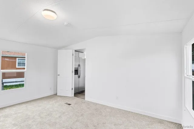 an empty room with windows and closet