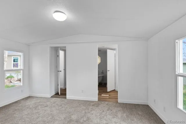 an empty room with windows and closet