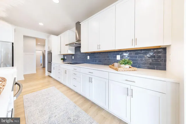 a spacious bathroom with stainless steel appliances double vanity sink and mirror