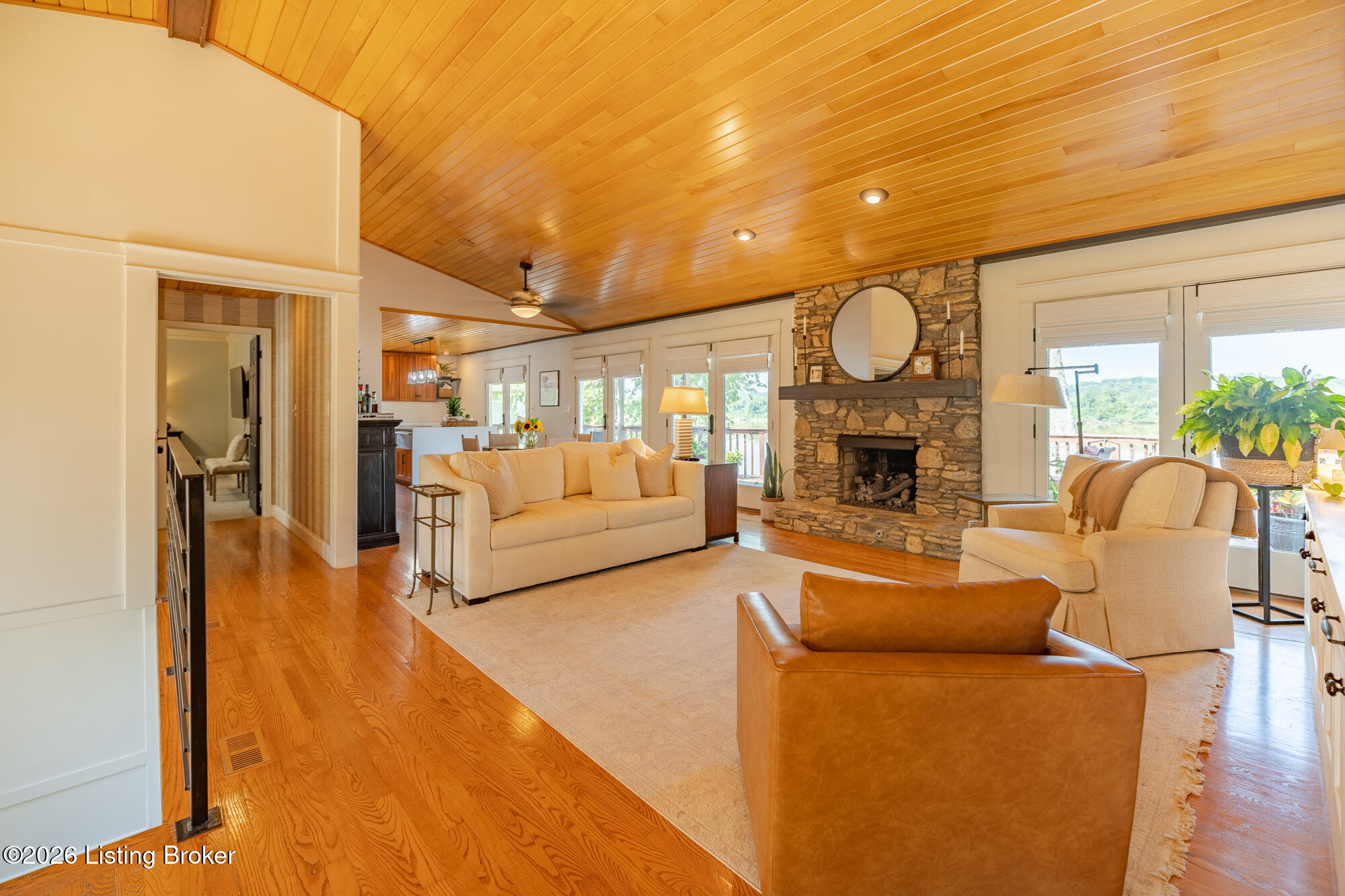 3028 Belknap Beach Road Prospect, KY 40059 - Photo 14 of 70 Inviting great room with stone gas fireplace and several patio doors leading the the expansive deck