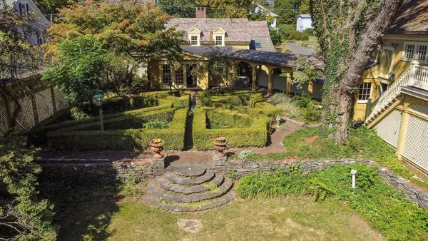 a front view of a house with garden