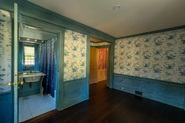 a bathroom with a sink a toilet and mirror