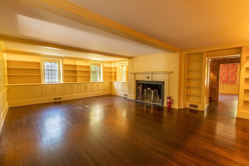 105 Church Street Ware, MA 01082 - Photo 16 of 41 a view of empty room with wooden floor and fireplace