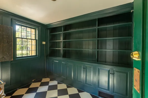 a view of empty room with wooden floor and fireplace